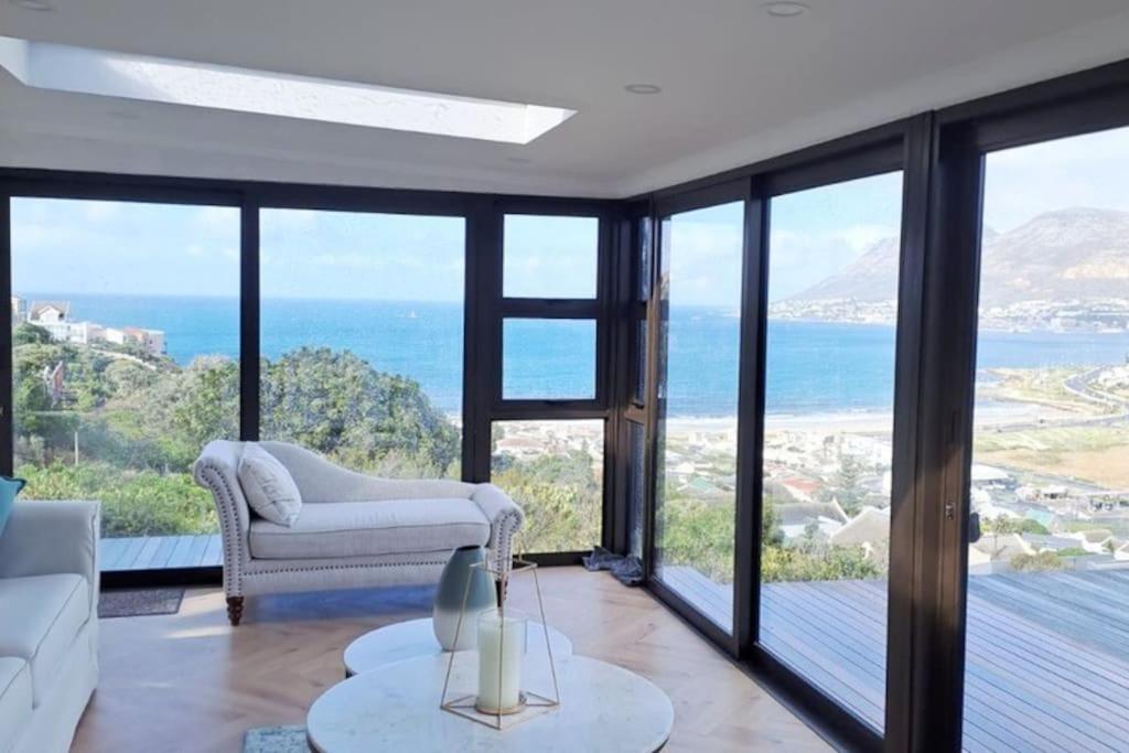 a living room with a view of the ocean at Modern mountainside home with ocean view - Minimal load shedding in Cape Town