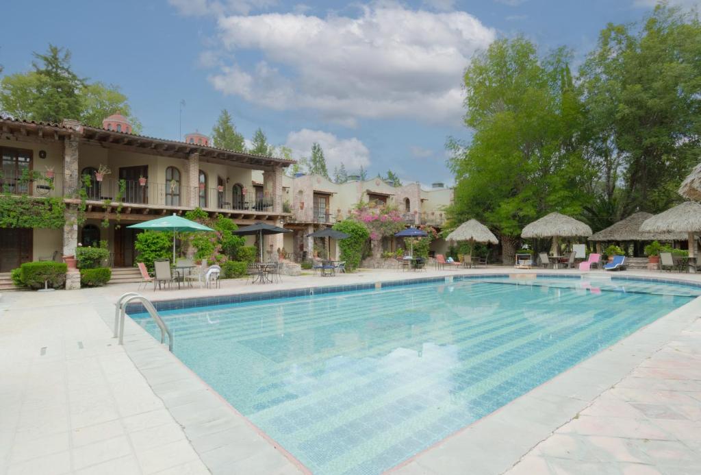 a large swimming pool in front of a hotel at Atotonilco Hotel & Club in Atotonilco