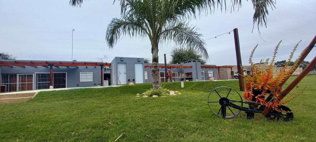 a garden with a tractor in the grass with a building at Cabañas Don Tatin in La Banda