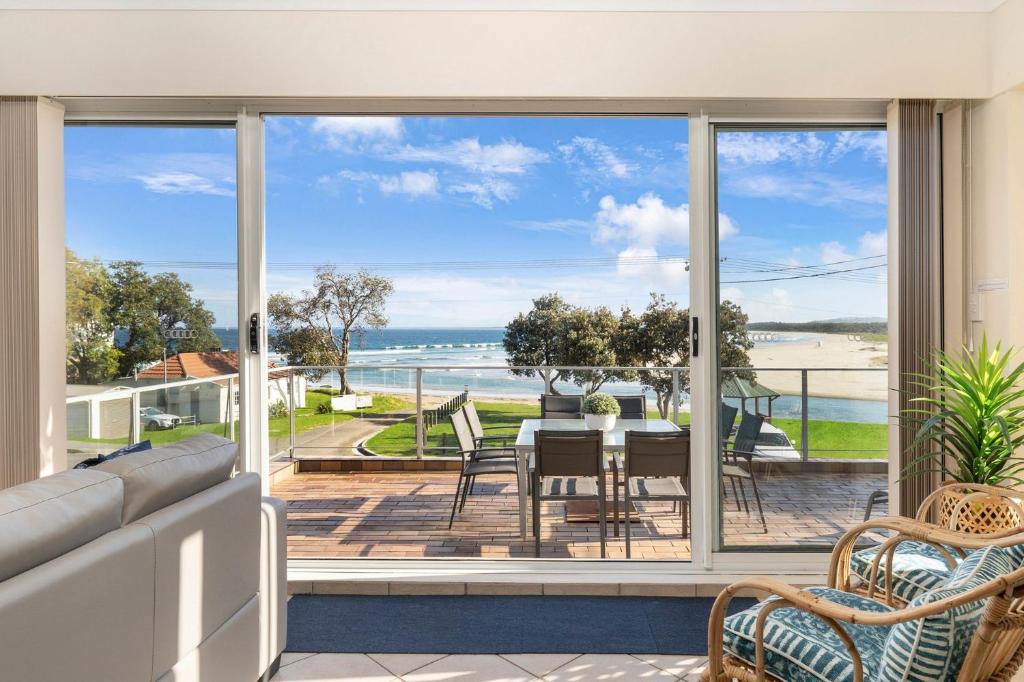 a living room with a view of the ocean at The Rotunda, Gerroa in Gerroa