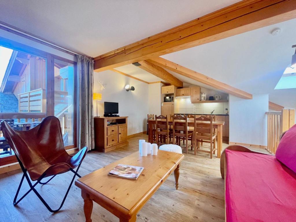 a living room with a table and a dining room at Charmant duplex 6 pers au cœur du village avec piscine et parking - FR-1-505-192 in Notre-Dame-de-Bellecombe