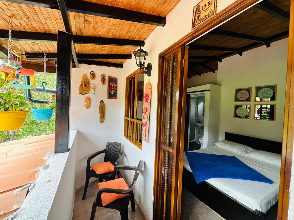 a small bedroom with a bed and a balcony at Casa Hotel Camino Real in Guadalupe