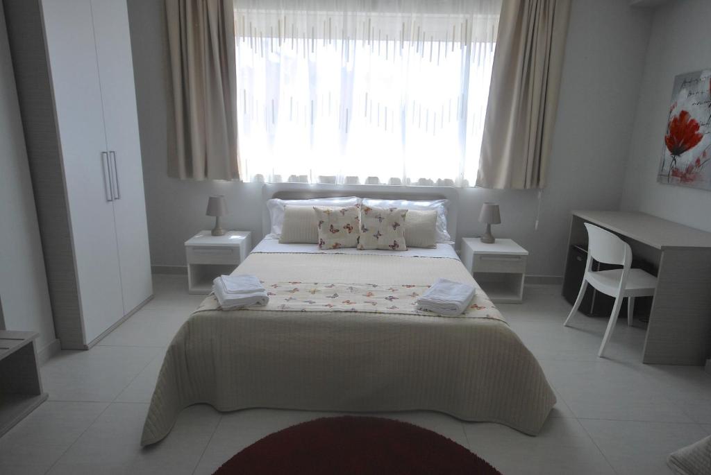 Postel nebo postele na pokoji v ubytování Pietra Bianca Rooms