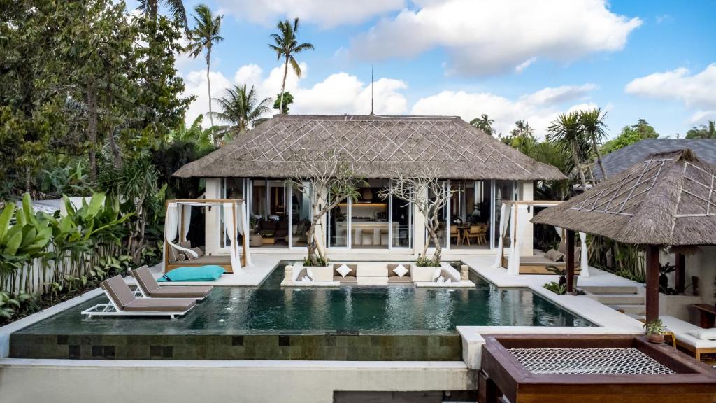 a villa with a swimming pool and a resort at Villa Gian Minima by BaliSuperHost in Ubud