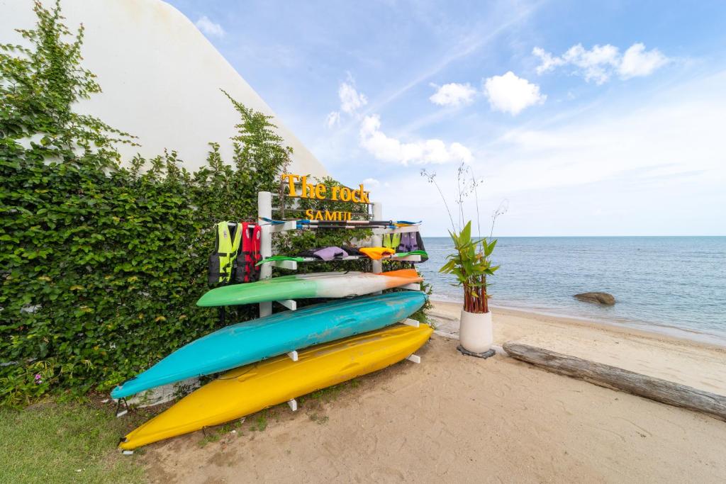 a group of surfboards lined up on the beach at The Rock Samui - formerly known as The Rock Residence - SHA Extra Plus in Lamai