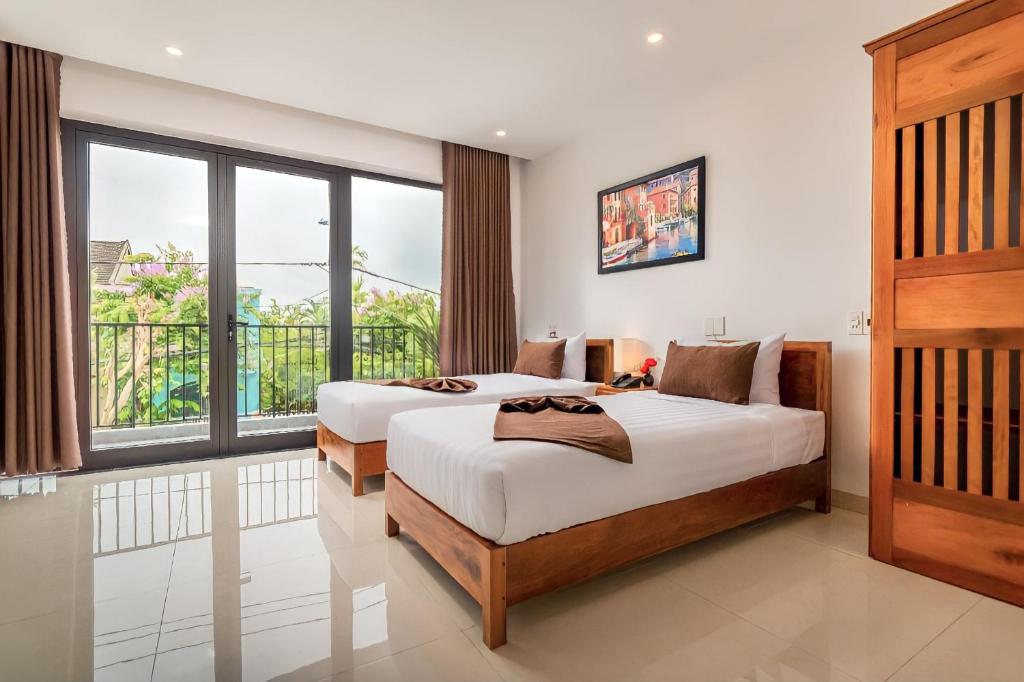 Postel nebo postele na pokoji v ubytování Tomorrow Hoi An Villa