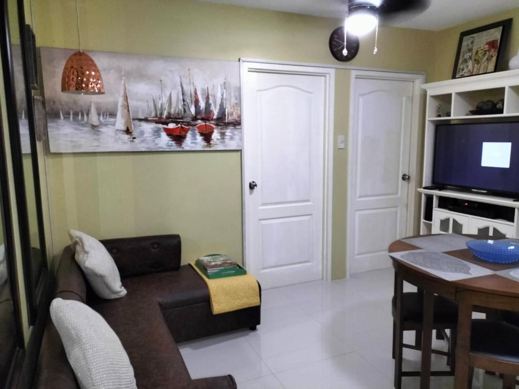 a living room with a couch and a table at City condo in Talisay