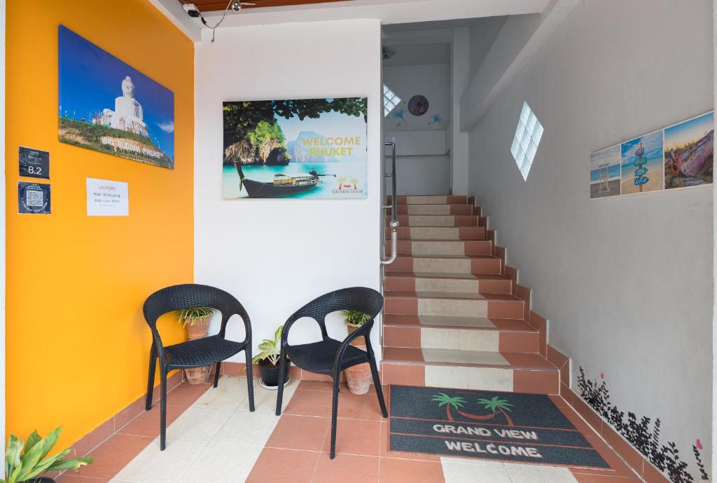 two chairs and a staircase in a room at Grand View in Patong Beach