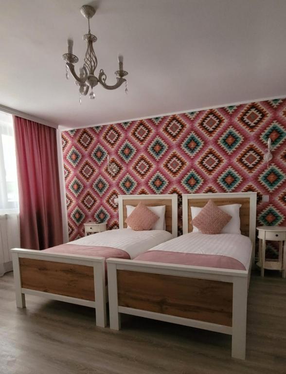 Postel nebo postele na pokoji v ubytování Casa Domnească