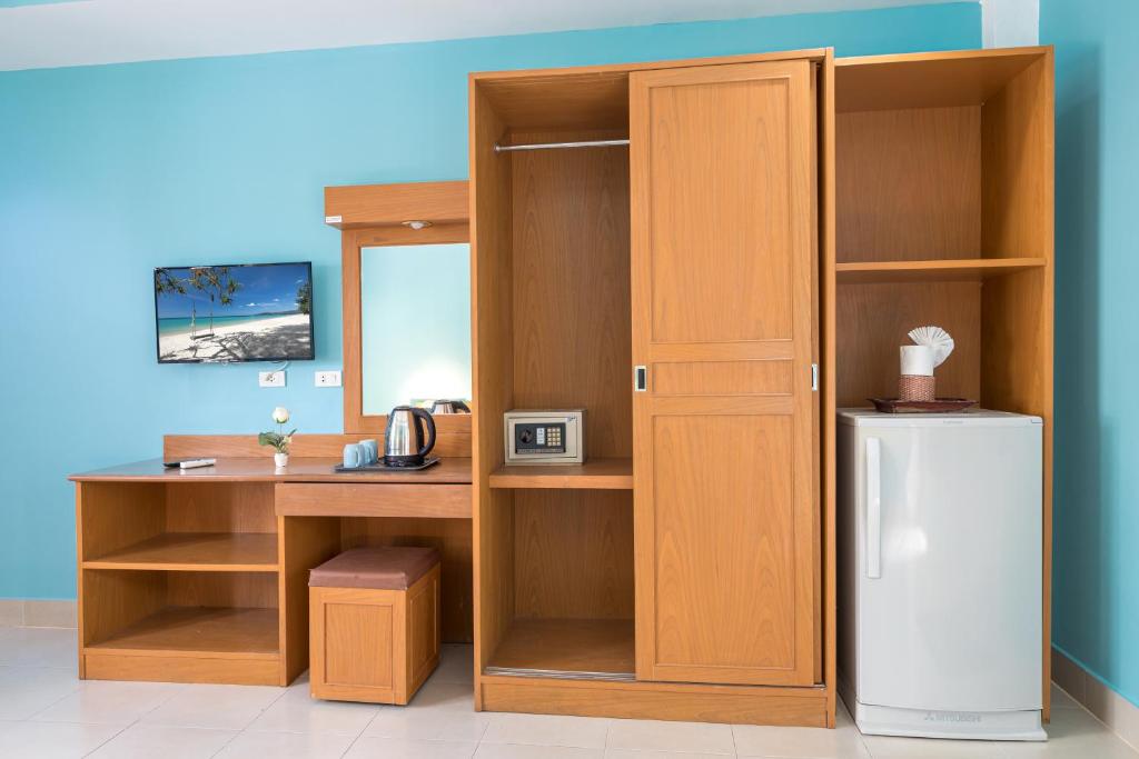 a room with a desk and a refrigerator in it at Grand View in Patong Beach