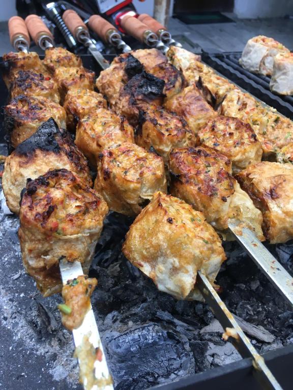 a bunch of food cooking on a grill at Old House Gyumri in Gyumri