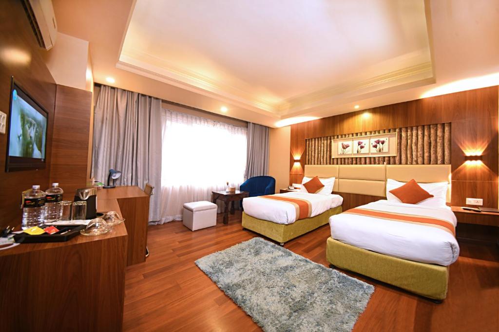 Postel nebo postele na pokoji v ubytování Kumari Boutique Hotel