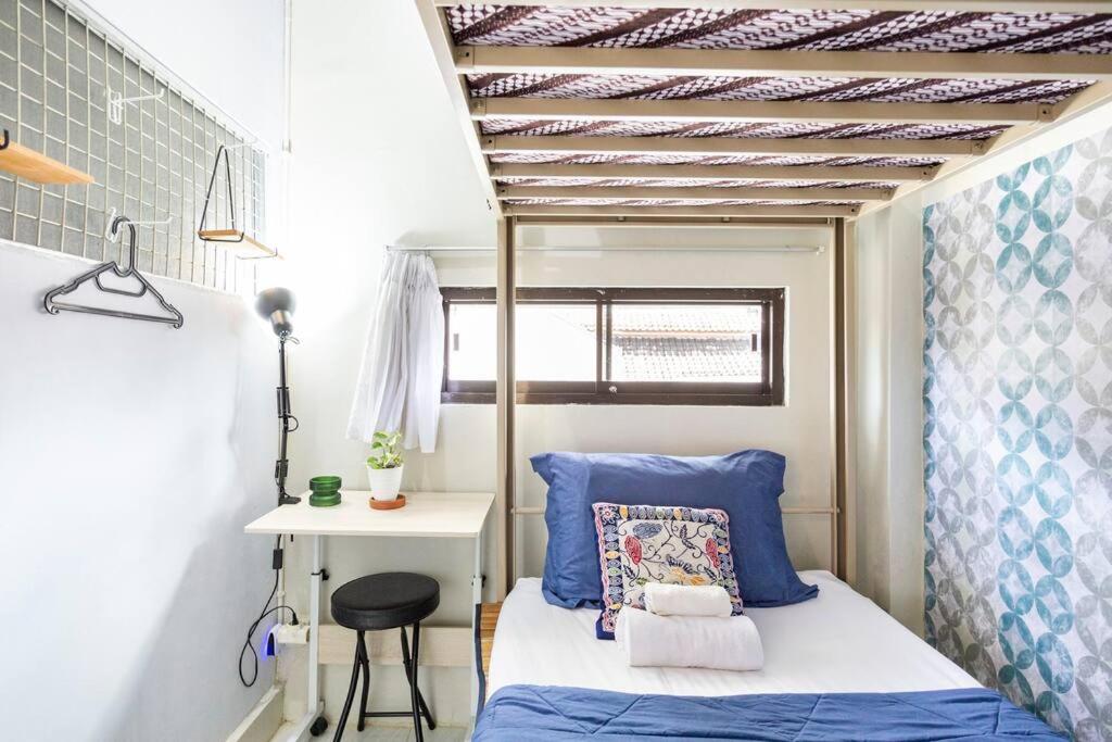 a small bedroom with a bed and a desk at Teras Sabin in Ngabean