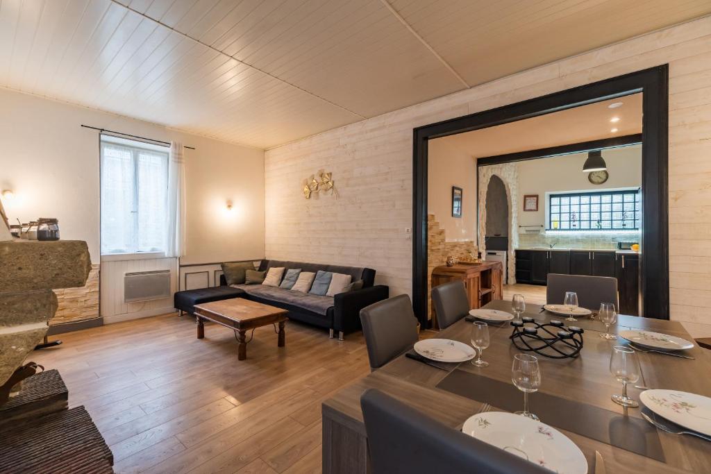 a living room with a table and a couch at Les Choucas - Maison pour 9 avec terrasse in Plouaret