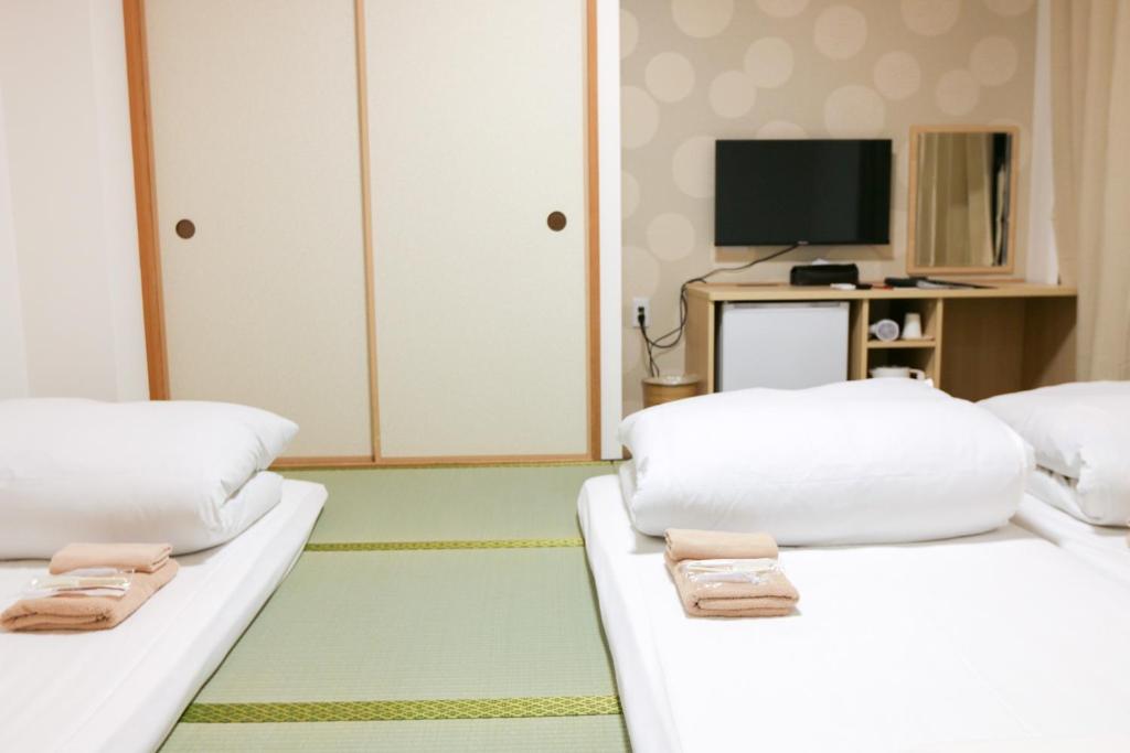 大阪市にあるHotel Shin-Imamiya - Vacation STAY 36315vのテレビ付きの客室で、白いベッド2台が備わります。