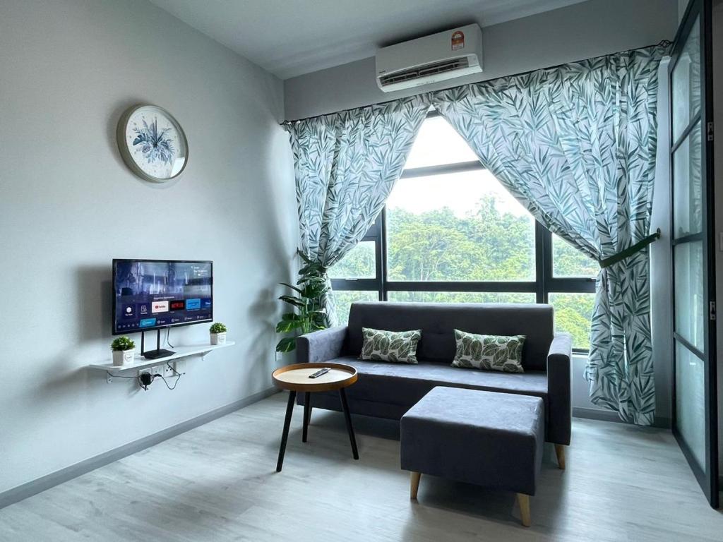 uma sala de estar com um sofá e uma grande janela em Jesselton Quay homestay with Free 1 parking by StayPlace em Kota Kinabalu