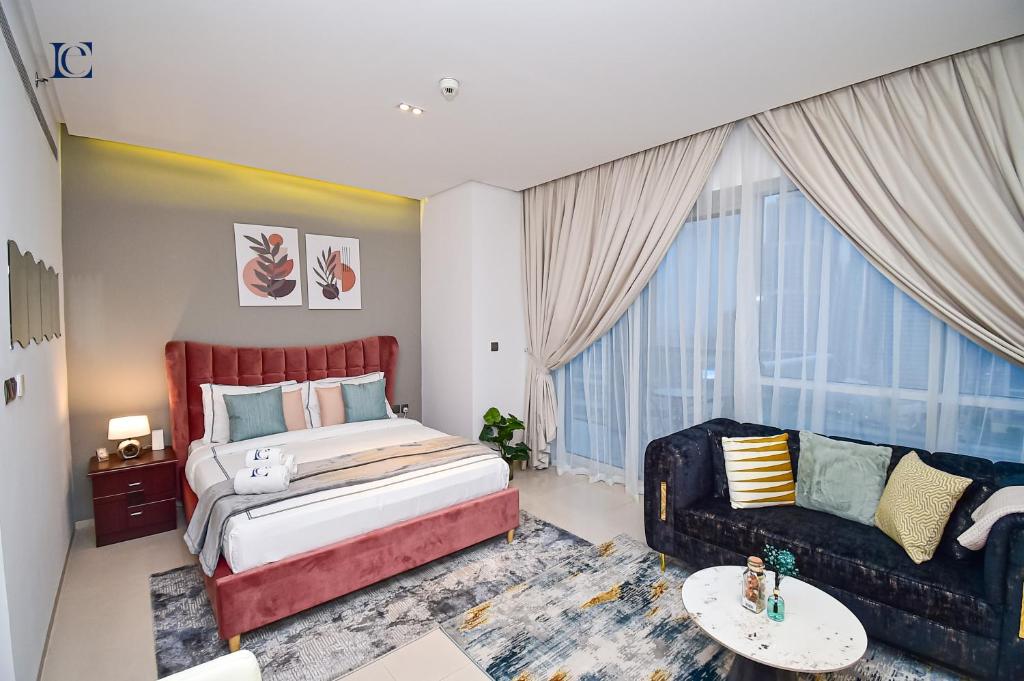 1 dormitorio con 1 cama grande y 1 sofá en AST - Modern studio in Dubai Marina en Dubái