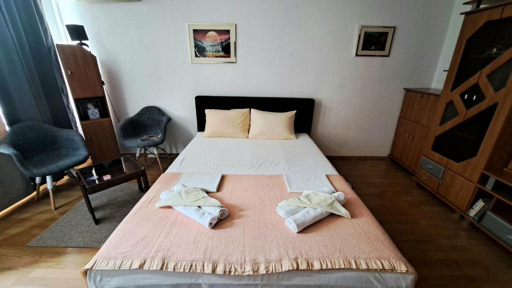 a bedroom with a bed with two towels on it at Apartman Bella Ilidža in Sarajevo