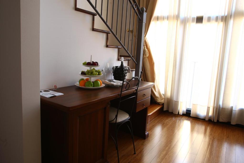 a room with a table with a bowl of fruit on it at Hotel San Rocco in Muggia