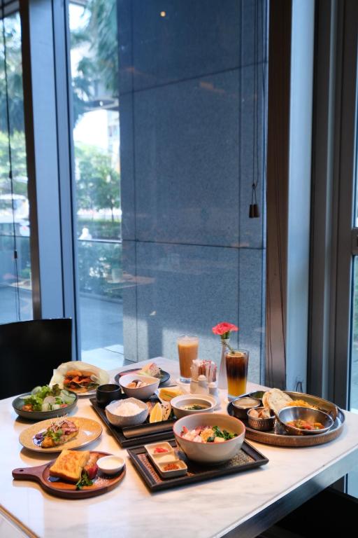 a table with a bunch of food on it at Bangkok Marriott Hotel Sukhumvit in Bangkok