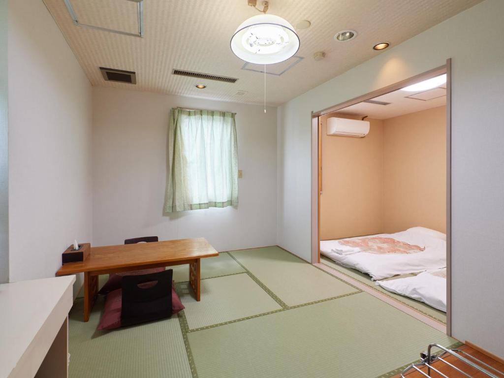 Postel nebo postele na pokoji v ubytování Sakura no Yakata Hotel