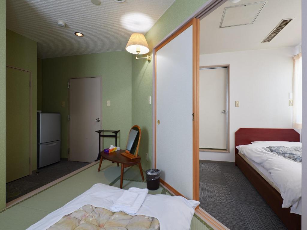 Postel nebo postele na pokoji v ubytování Sakura no Yakata Hotel