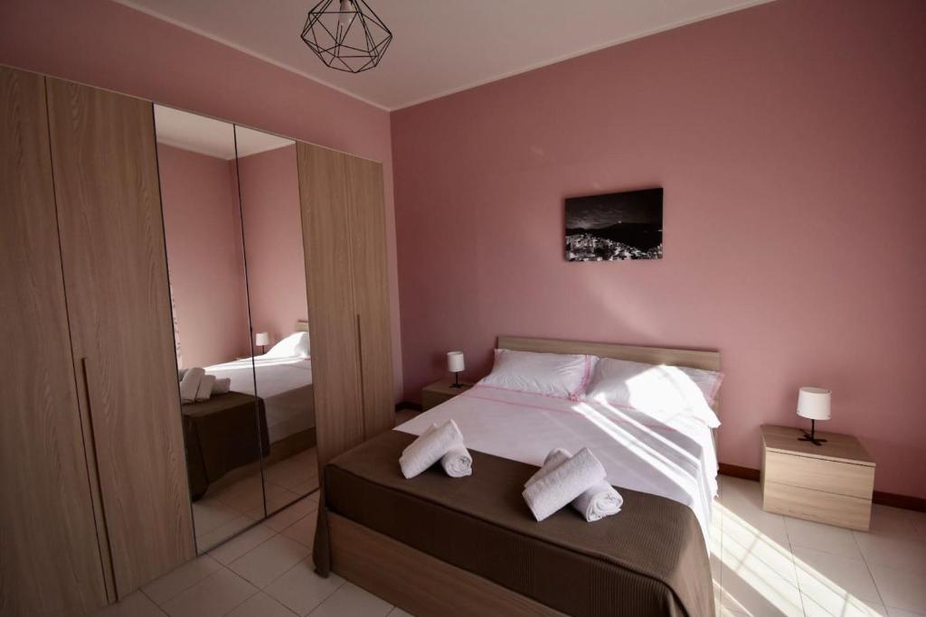 a bedroom with a bed with two towels on it at Casa San Martino in Castiglione di Sicilia