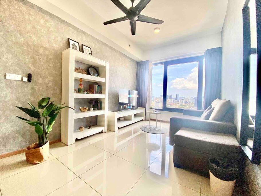 a living room with a couch and a ceiling fan at Tropicana 218 Macalister - Georgetown Family Homely 2BR Suite in George Town