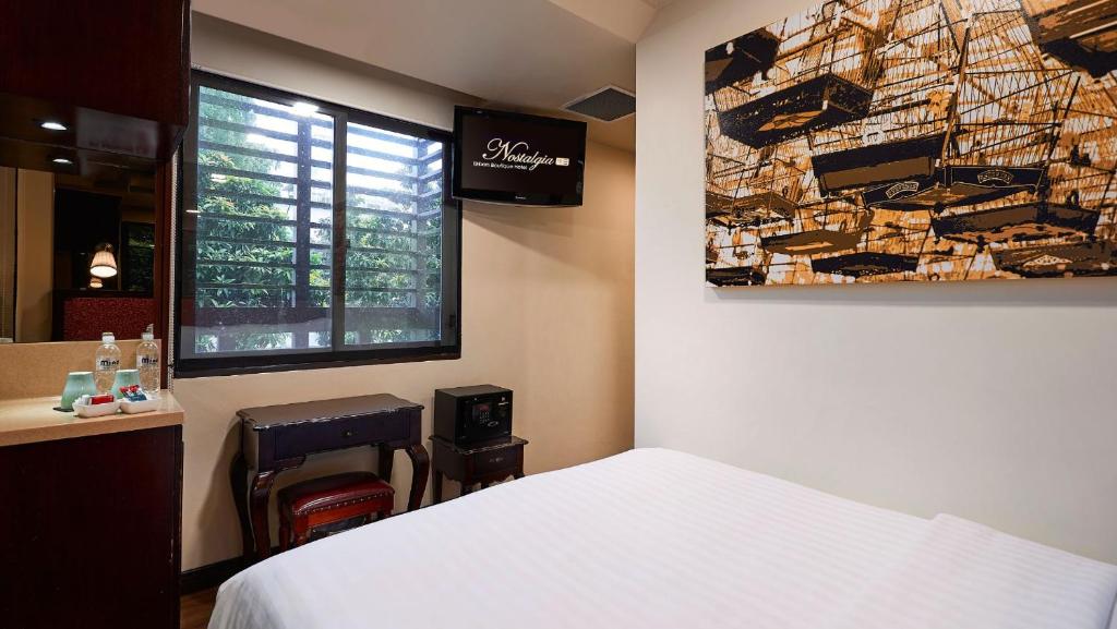 Postel nebo postele na pokoji v ubytování Nostalgia Hotel