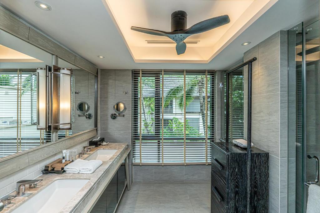 a bathroom with two sinks and a ceiling fan at Layana Resort & Spa - Adult Only - SHA Extra Plus in Ko Lanta
