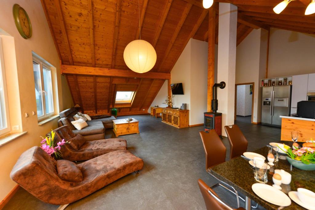 a living room with a couch and a table at Ferienwohnung im Erzgebirge in WeiÃŸbach