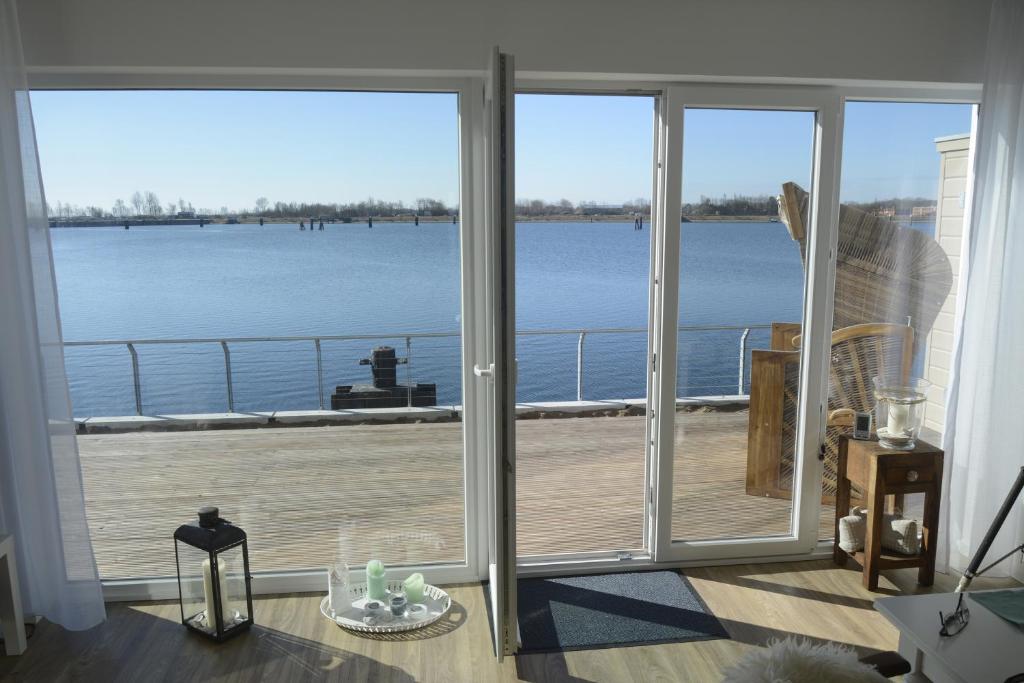 a room with a large window with a view of the water at Ferienwohnung OstseeBrise in Olpenitz