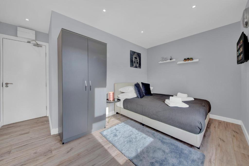 a bedroom with a bed and a sliding glass door at Lovely 1-Bed Studio in West Drayton in West Drayton