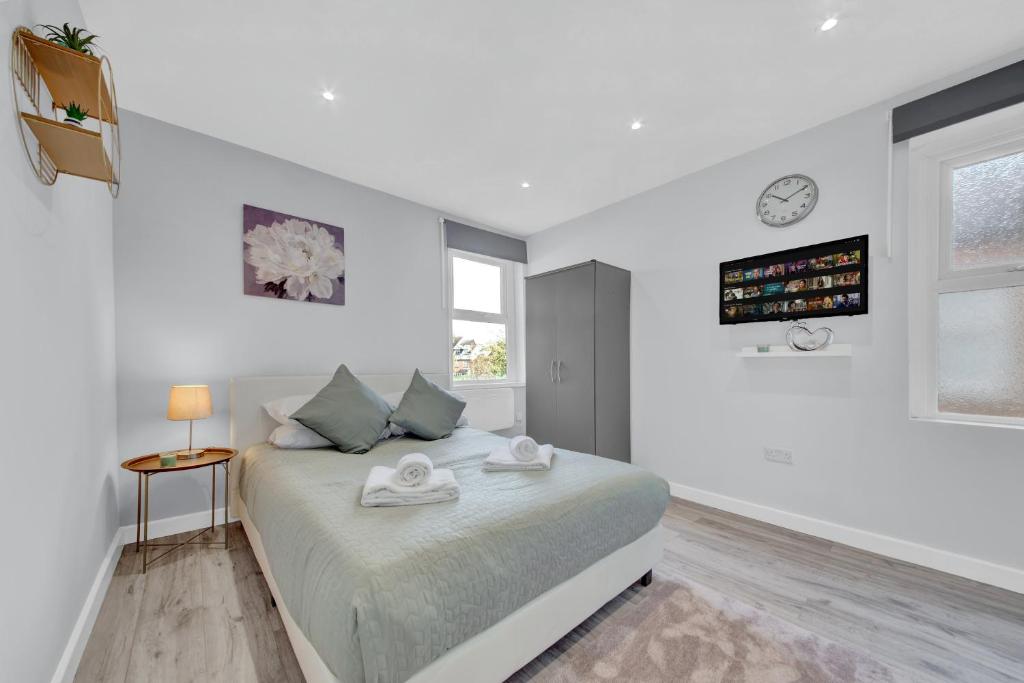 a white bedroom with a bed and a window at Captivating 1-Bed Studio in West Drayton in West Drayton