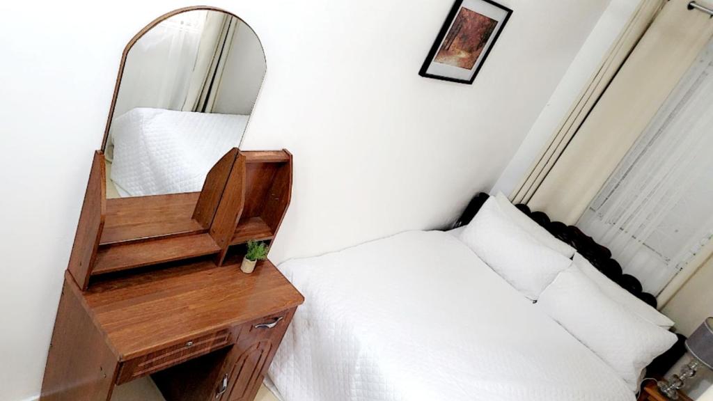 a bedroom with a mirror and a desk and a bed at Zanzibar Town house in Ngambo