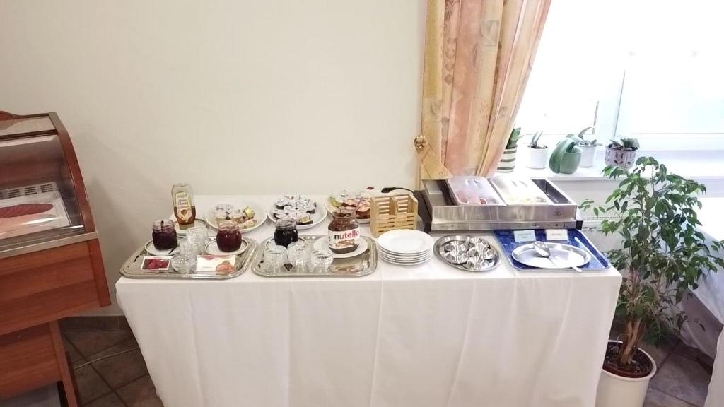 a table with plates of food on it at Hotel Sorella in Ittlingen