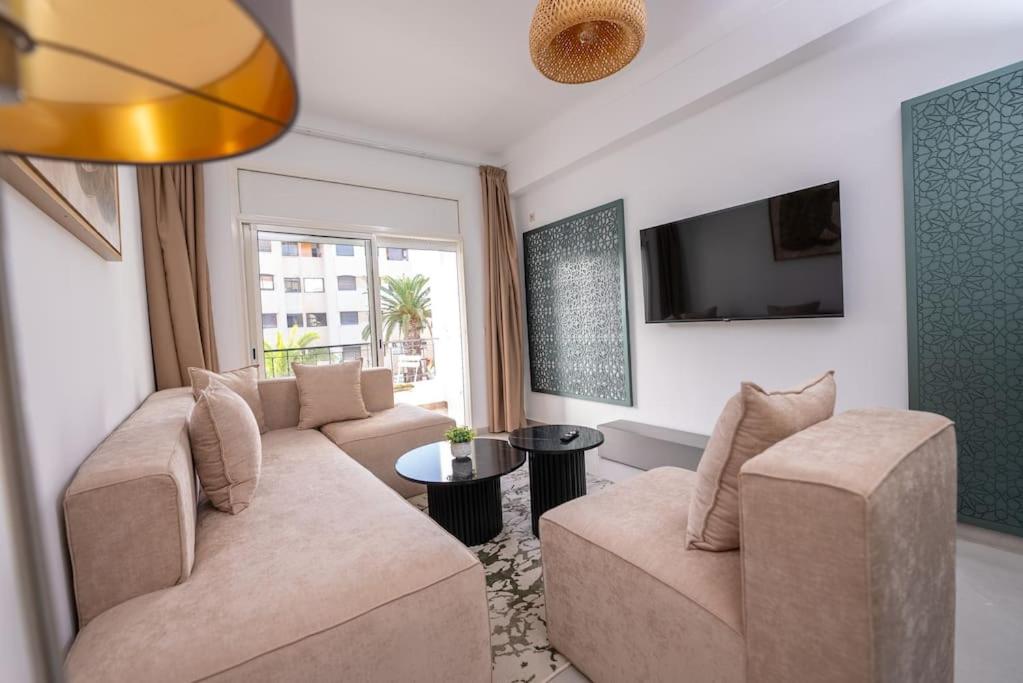 a living room with two couches and a tv at Tradition Meets Modern: 2BR Flat in Rabat Hassan in Rabat