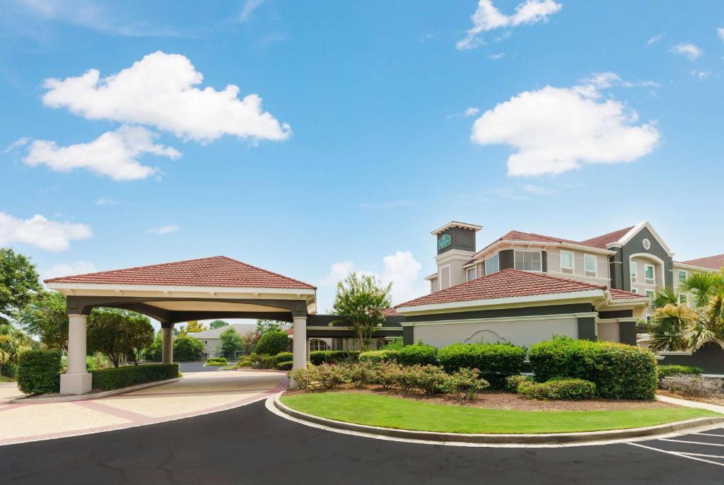 a house with a gazebo on a street at La Quinta by Wyndham Myrtle Beach Broadway Area in Myrtle Beach