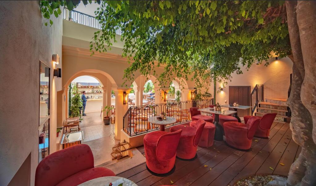 a restaurant with red chairs and tables in a building at La Fonda Heritage Hotel Luxury, Relais & Châteaux in Marbella