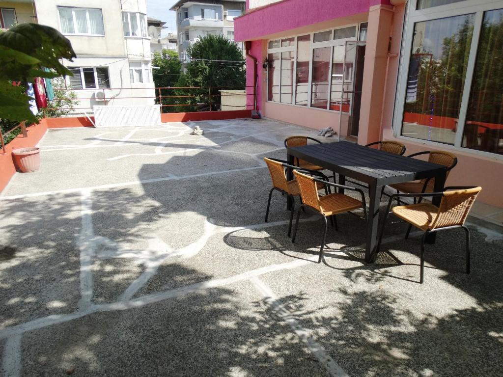 a black table and chairs on a patio at Apartaments Viktoria in Silistra