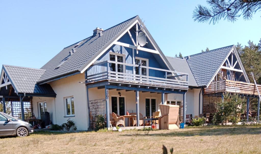a large house with a gambrel roof at Niebieski dom in Białogóra