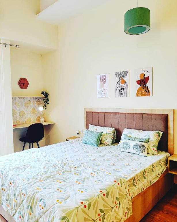 een slaapkamer met een groot bed met kleurrijke kussens bij Hey Studio's With Balcony in Ghaziabad