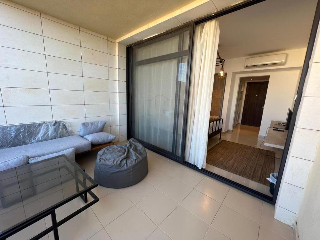 a living room with a couch and a large window at Studio EL Gouna G-Cribs in Hurghada