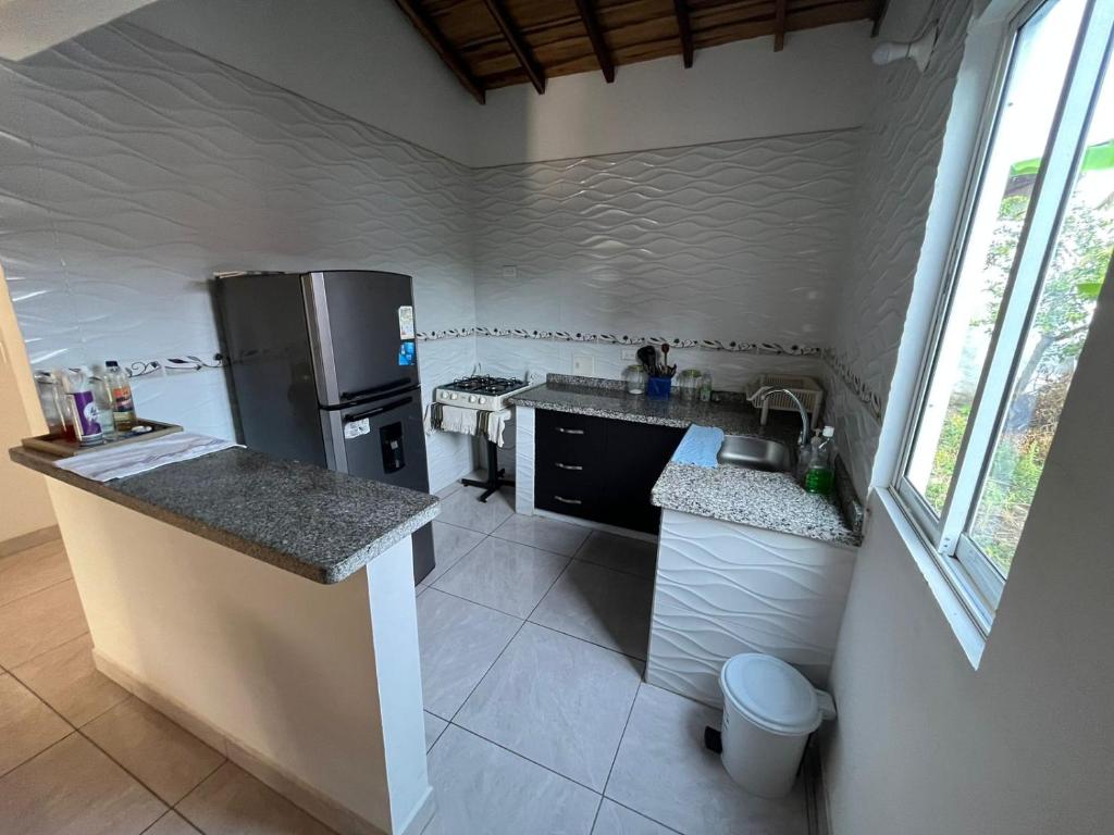 a kitchen with a refrigerator and a counter top at HOSTAL JOSE NAVARRO in Guadalupe
