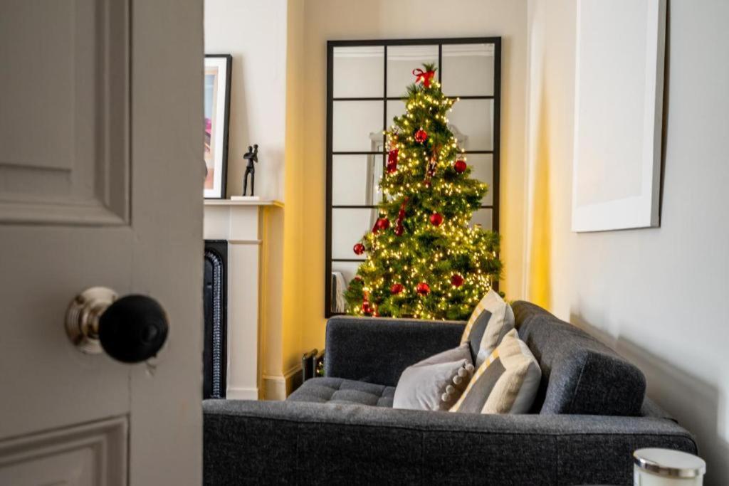a christmas tree in a living room with a couch at 42 is the Answer- Stunning York townhouse appearing on TV Holiday Home Show in York
