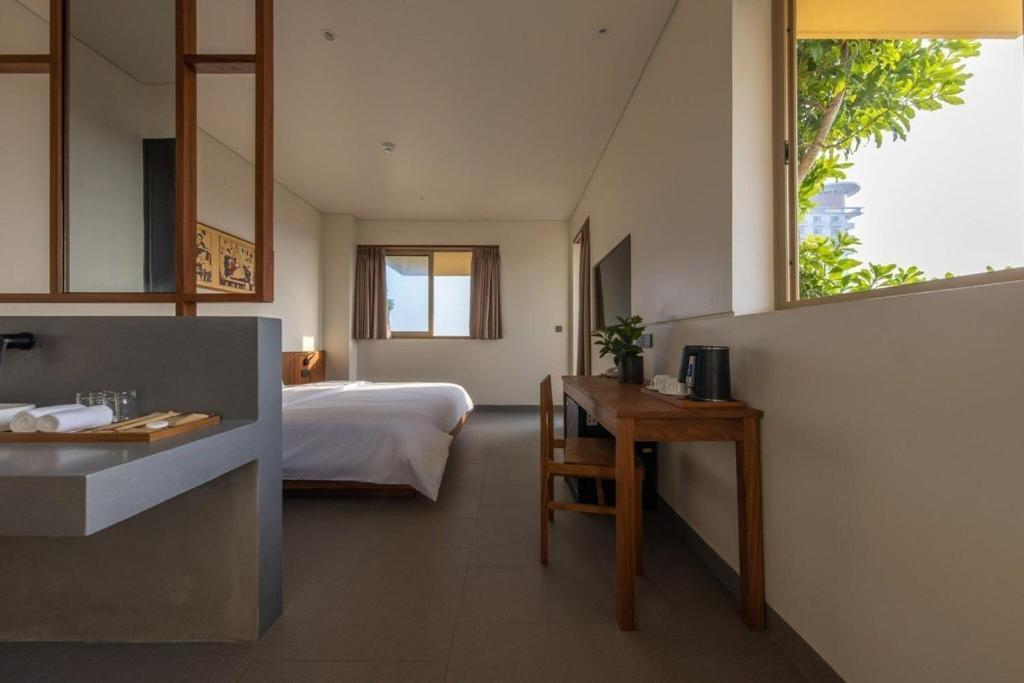 Postel nebo postele na pokoji v ubytování Cát Vàng Hotel & Apartment