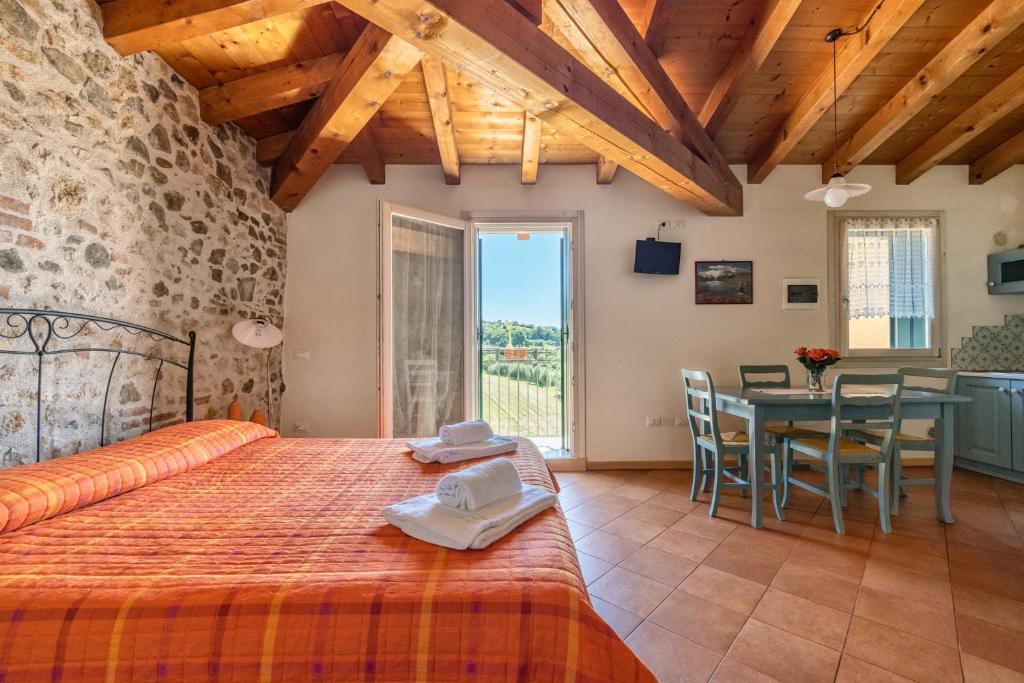 a bedroom with a large bed and a dining room at L'Oro Rosso in Marostica