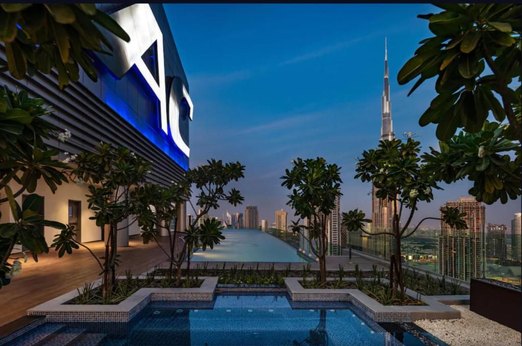 a view of the burj khalifa from a building with a swimming pool at Paramount Hotel Apartment Midtown - Platinium Dubai in Dubai