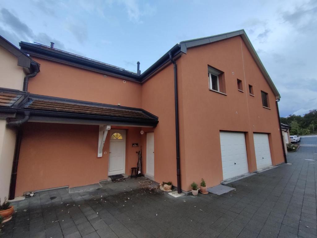 a large orange building with two garage doors at Studio with private bathroom in Geneva