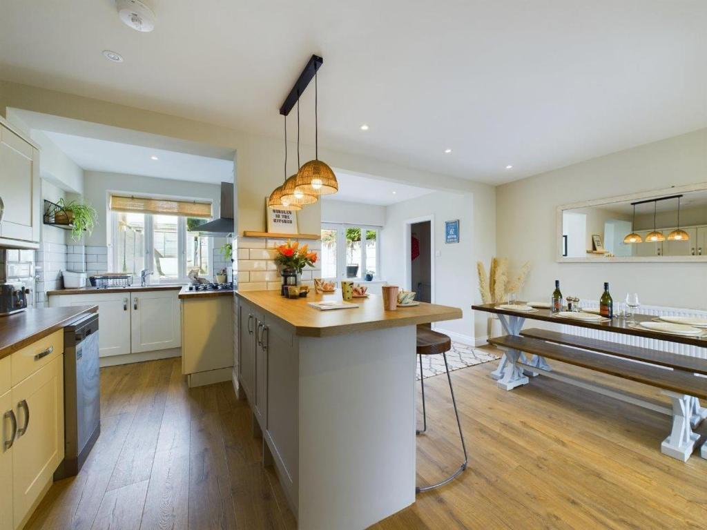 a large kitchen with a large island in the middle at Stones Throw - stunning house, mins from beach and dogs welcome in Broadstairs